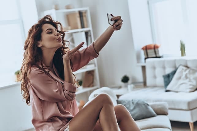 a beautiful curly woman taking a selfie