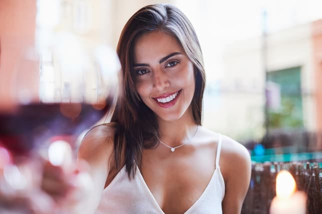 a selfie of an attractive young woman with long straight hair who is smiling and posing