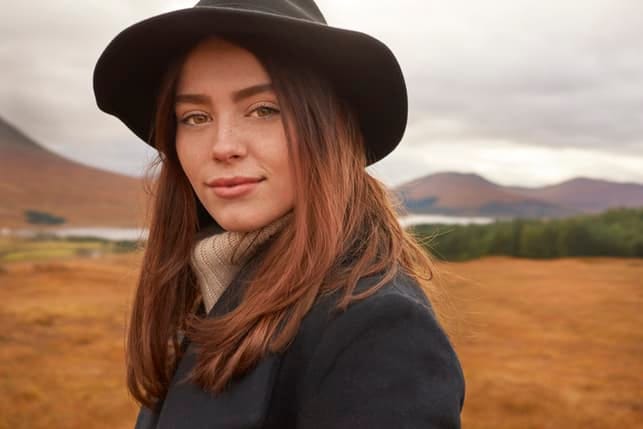 a portrait of a sad girl in a hat