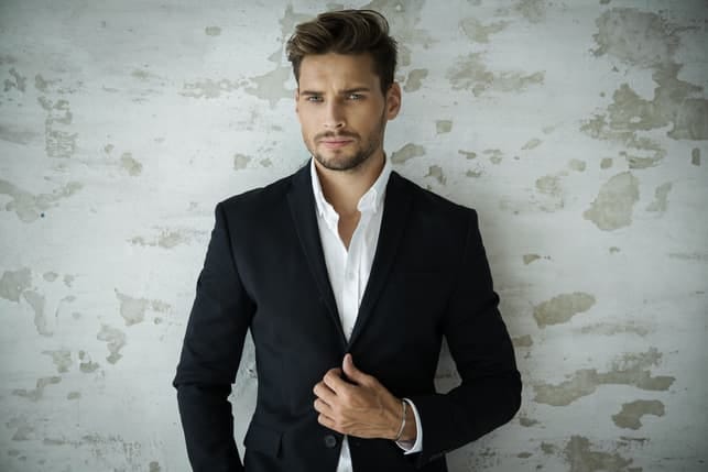 a portrait of a young man in a black suit