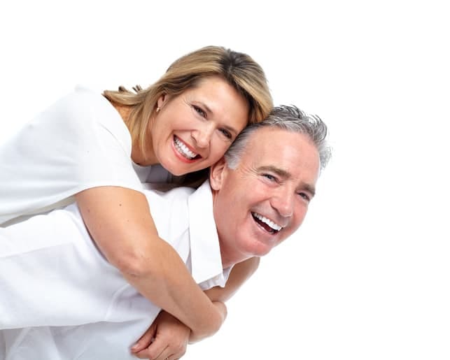 a mature couple hugging and posing together
