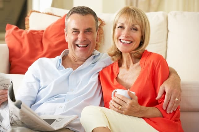 a mature couple smiling and posing together
