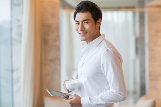 an attractive asian man in a white shirt smiling