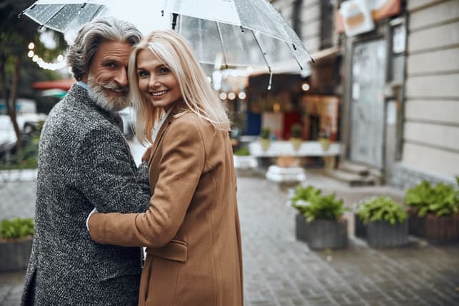 a fashionable mature couple having a walk together