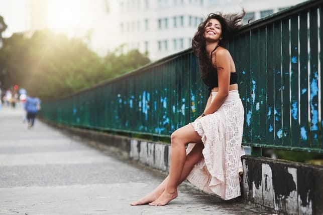 a beautiful woman posing on a bridge