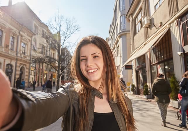 girl with a cheerful smile chilling in the city