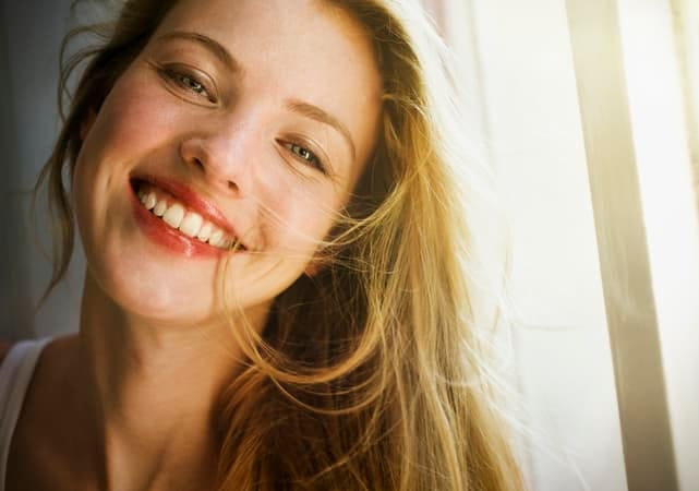 a portrait of a beautiful blonde woman smiling